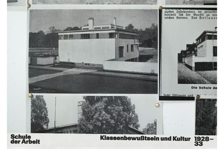 Historische Fotos und Zeitungsausschnitte zum Gebäude der Schule der Arbeit sind mit Reißzwecken an einer Tafel befestigt.