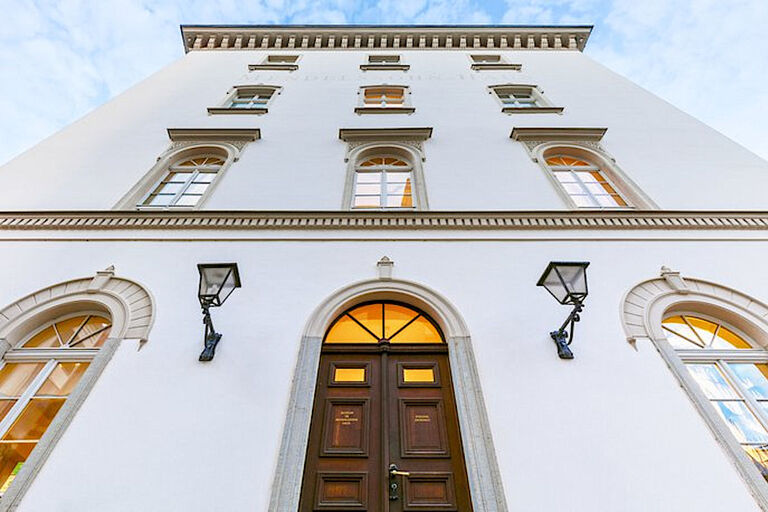 Außenansicht des historischen Mendelssohnhauses mit erleuchteten Fenstern
