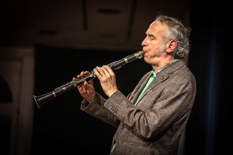 Der Klarinettist bei einem Konzert in Sacko und grünem Hemd