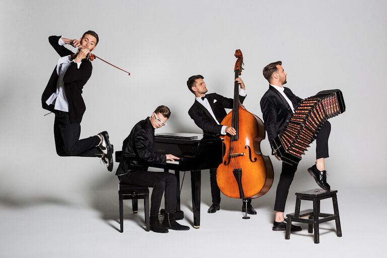 Gruppenfoto der Musiker mit ihren Instrumenten in etwasü bertriebenen Posen
